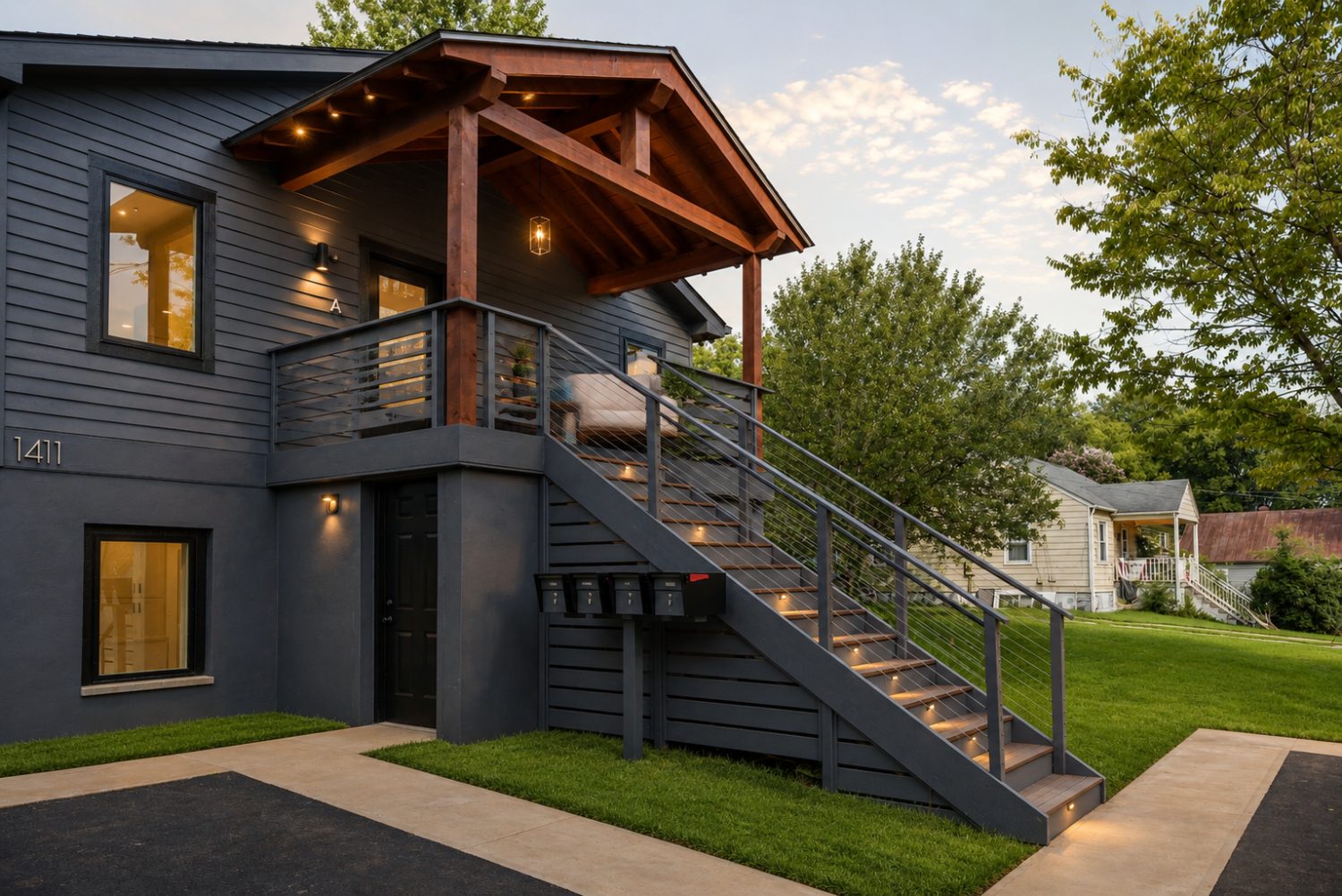 Exterior of Building A at dusk with timber-framed entry porch and open stair